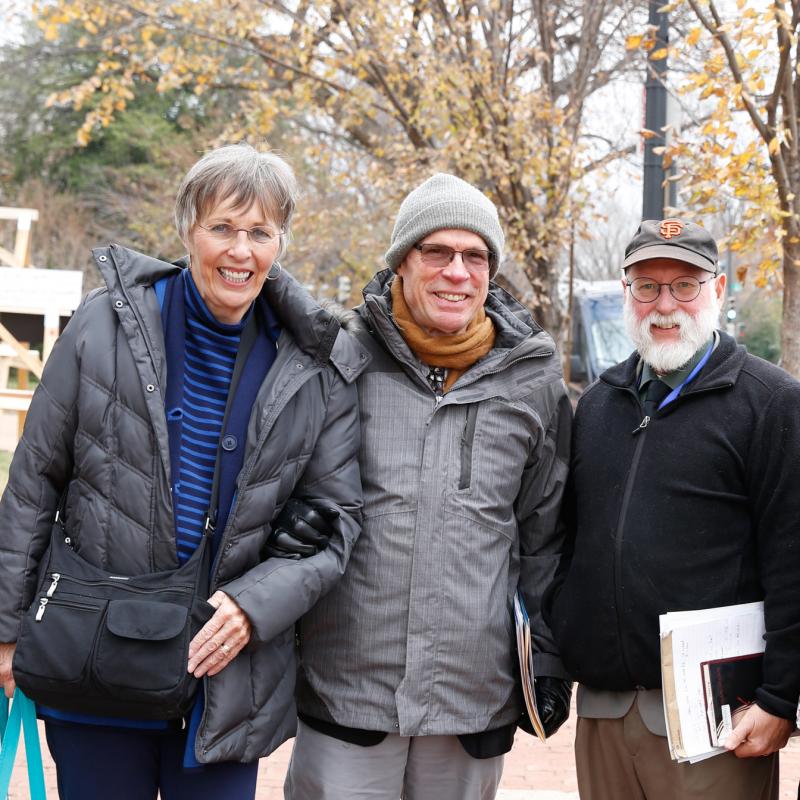 Four people stand together on East Capitol Street