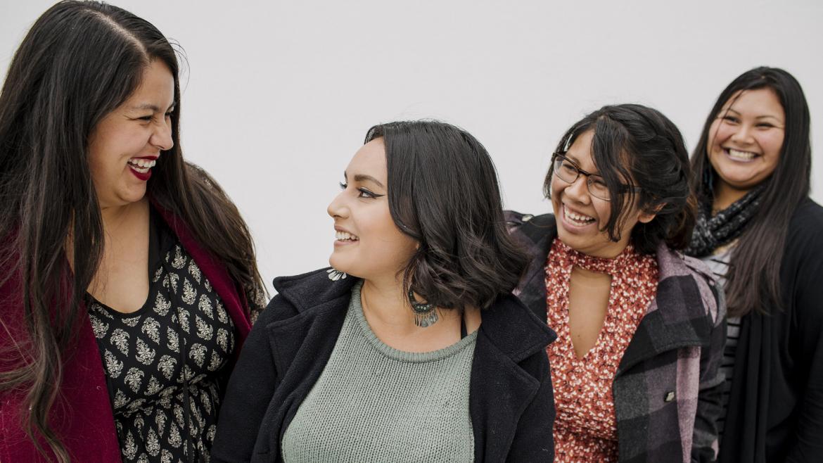 Four women laughing together 