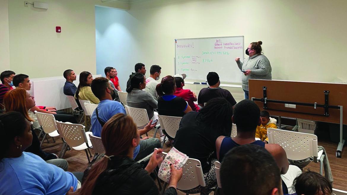 Friends Place Director Sarah Johnson conducts a midnight orientation session after a late night arrival of migrants from Texas. 